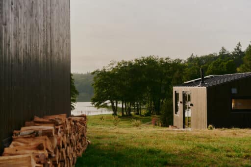 Small houses stand by a lake.