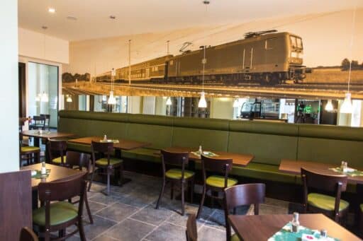 The bistro in the BahnhofsQuartier with a train-themed counter and decorations.