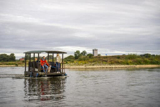 A raft with people sails past the old border tower in Darchau on the Elbe.