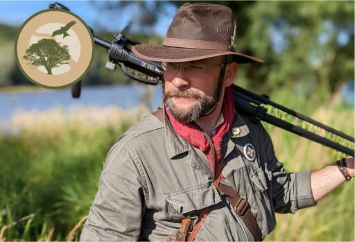 Certified nature and landscape guide Florian Baier with a ranger hat and a tripod.