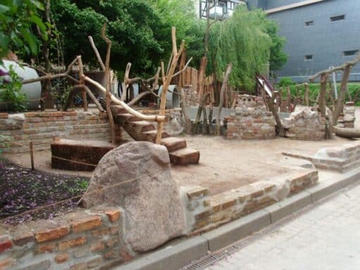 Natural playground in the kindergarten with wood and stone elements