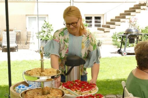 A woman serves a delicious cake in the manor house park