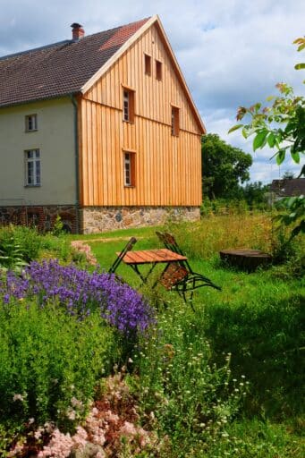 A house stands in a blooming garden