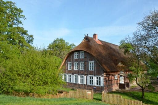 A half-timbered house stands on the dyke.