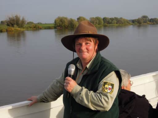 Ranger speaks into the microphone on a passenger ship