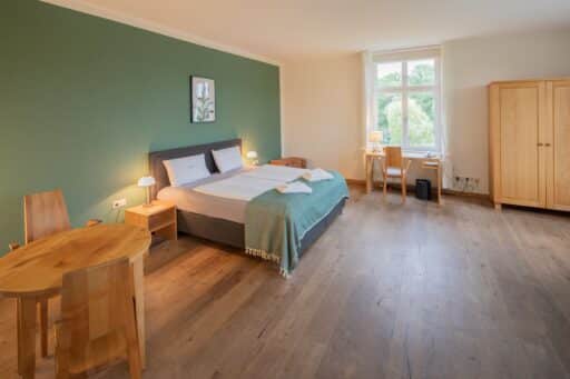 A hotel room in the castle hotel with wooden furniture.